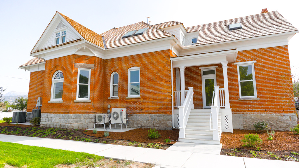 View of front of home with central AC