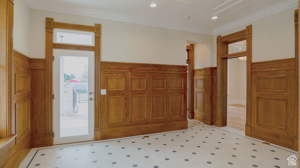 Foyer featuring ornamental molding and light hardwood / wood-style floors