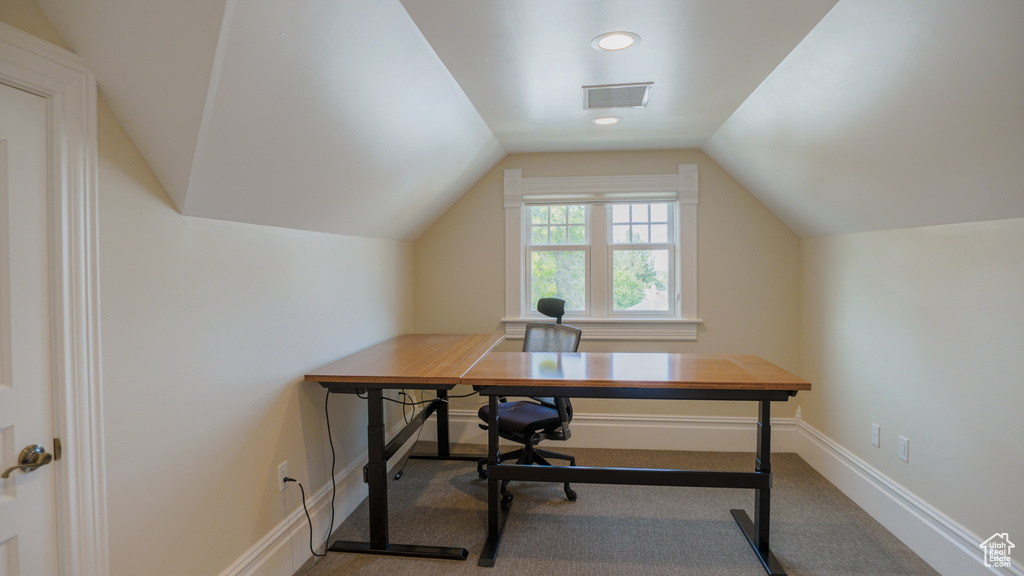 Carpeted office with vaulted ceiling