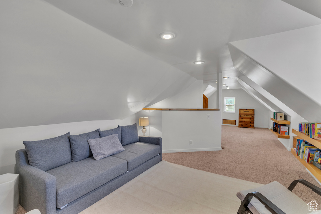 Living room featuring lofted ceiling and light carpet