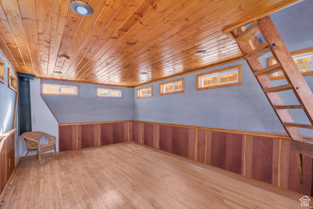 Interior space featuring light hardwood / wood-style floors, wooden walls, and wooden ceiling