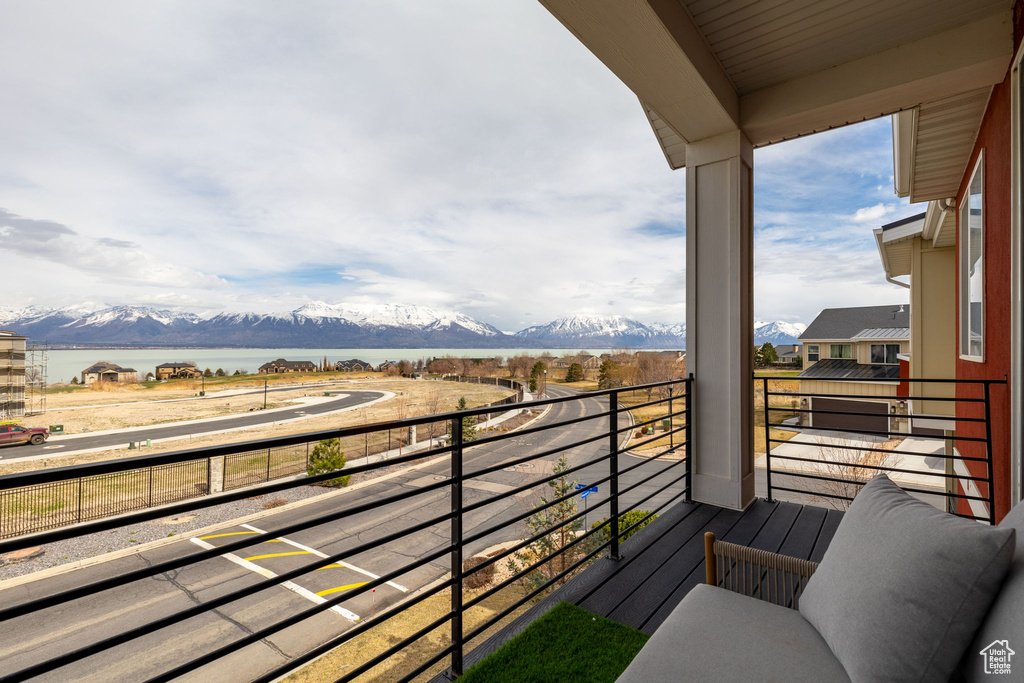 Balcony with a water and mountain view