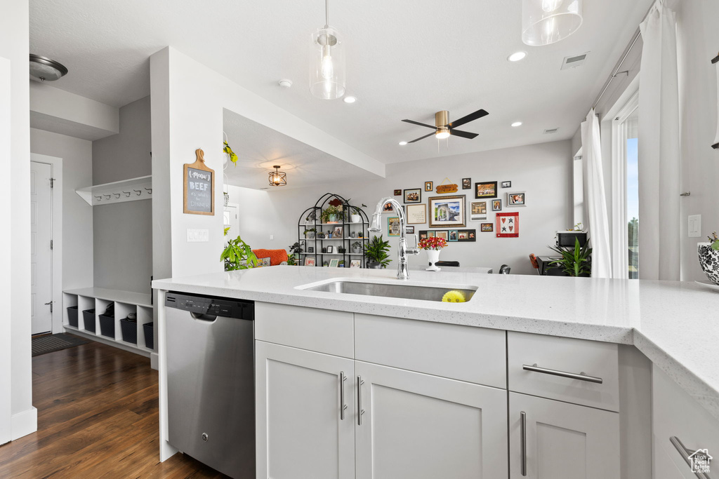 Kitchen featuring pendant lighting, sink, ceiling fan, dishwasher, and dark hardwood / wood-style flooring