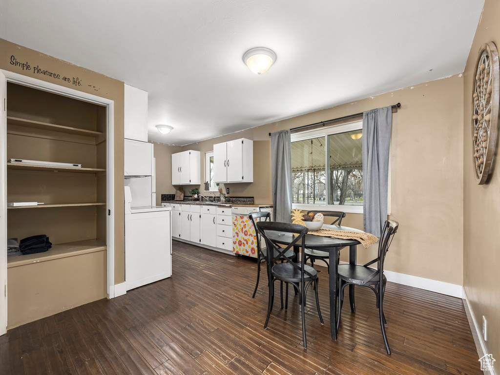 Dining room with washer / clothes dryer and dark hardwood / wood-style floors