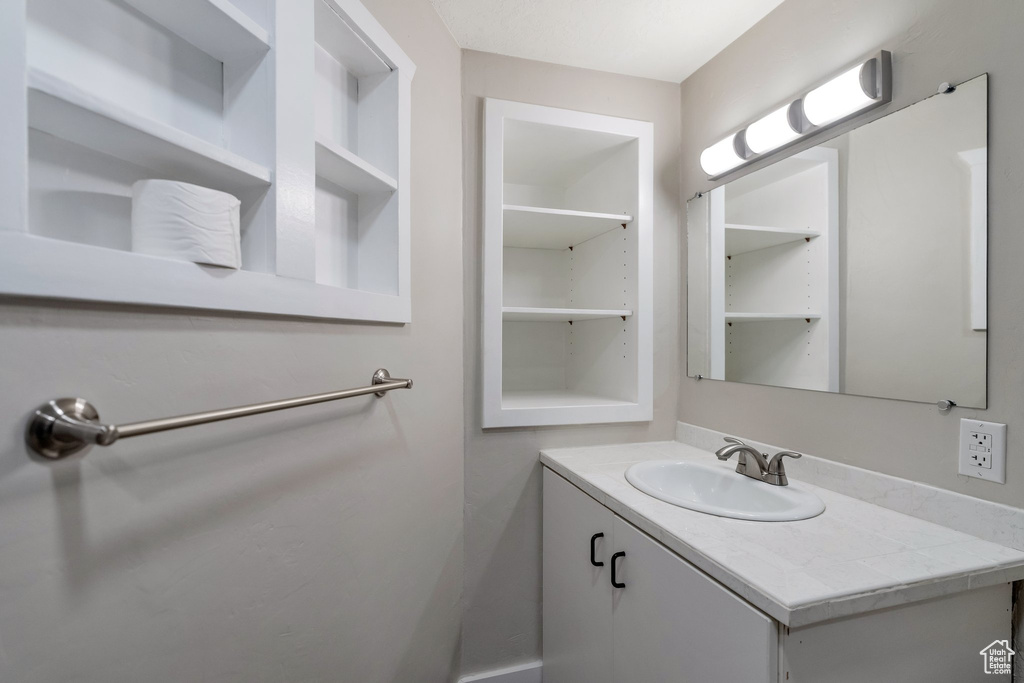 Bathroom featuring built in features and large vanity