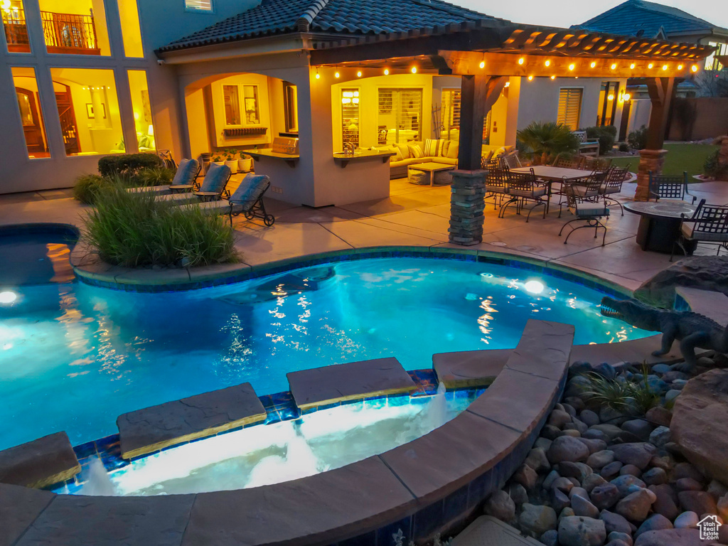 View of pool with an in ground hot tub and a patio