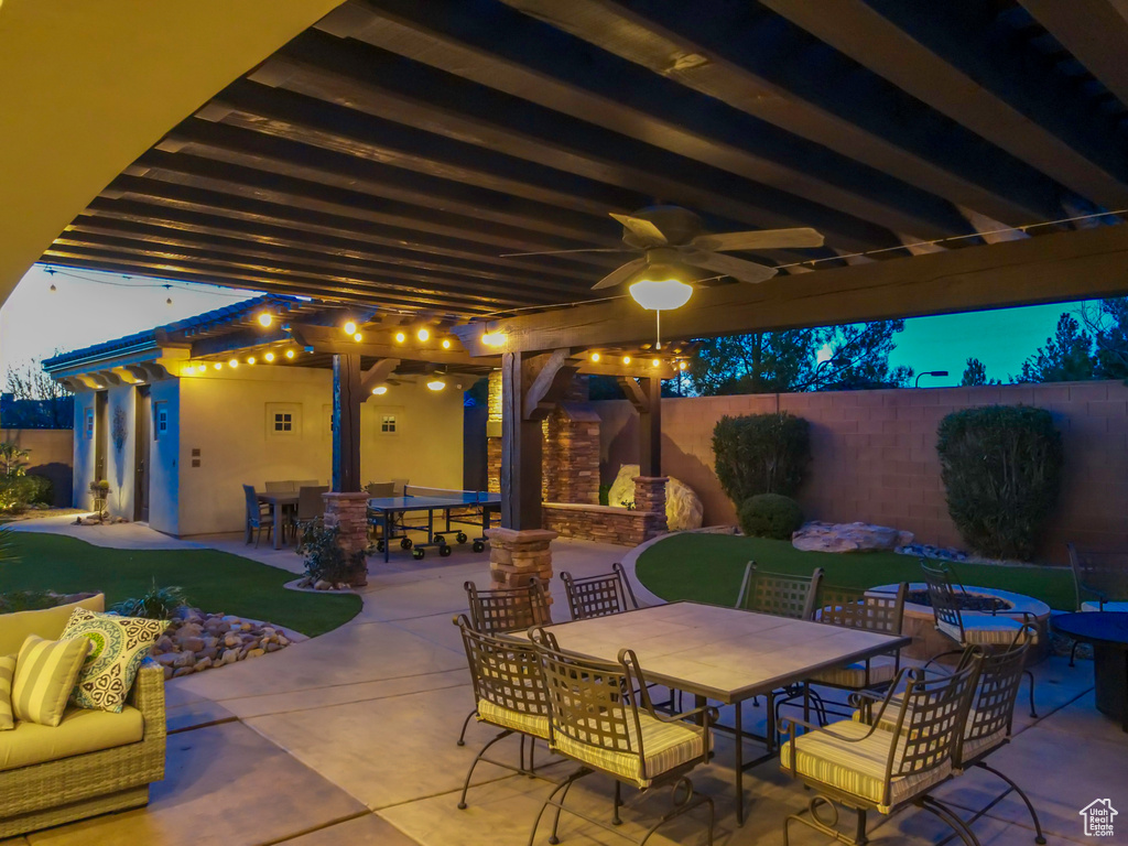 View of patio with an outdoor stone fireplace and ceiling fan