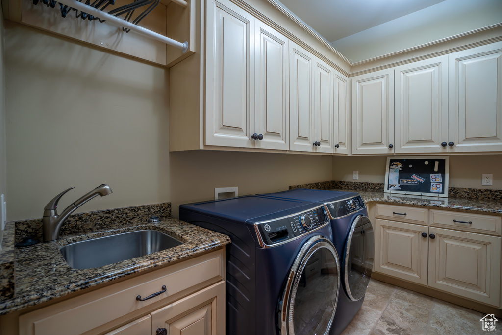 Laundry area with cabinets, light tile flooring, sink, washer and dryer, and hookup for a washing machine