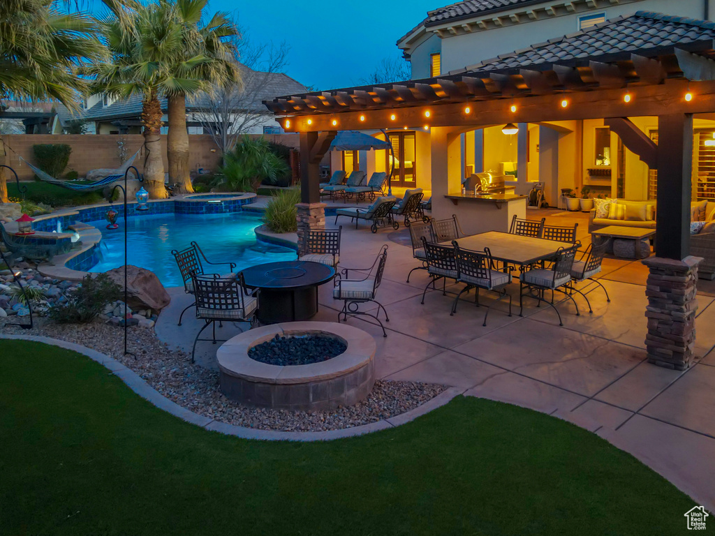 View of swimming pool with a patio, an in ground hot tub, a pergola, and an outdoor living space with a fire pit