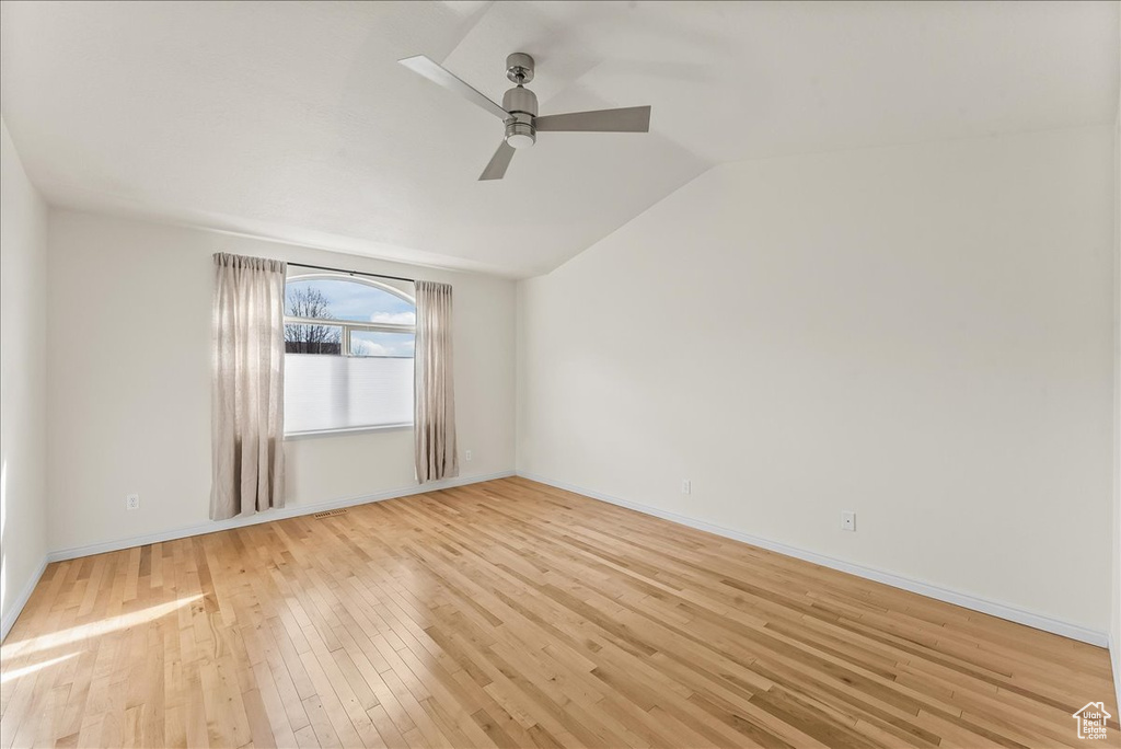 Unfurnished room with vaulted ceiling, ceiling fan, and light hardwood / wood-style floors