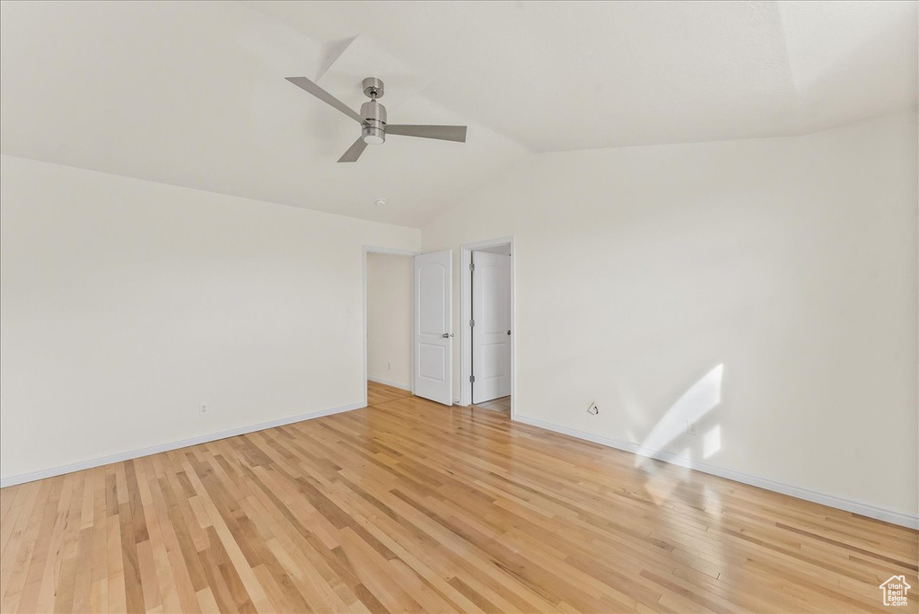 Unfurnished room with ceiling fan, lofted ceiling, and light hardwood / wood-style floors