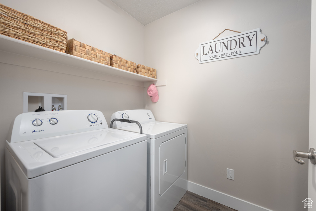 Laundry area with independent washer and dryer, washer hookup, and dark wood-type flooring