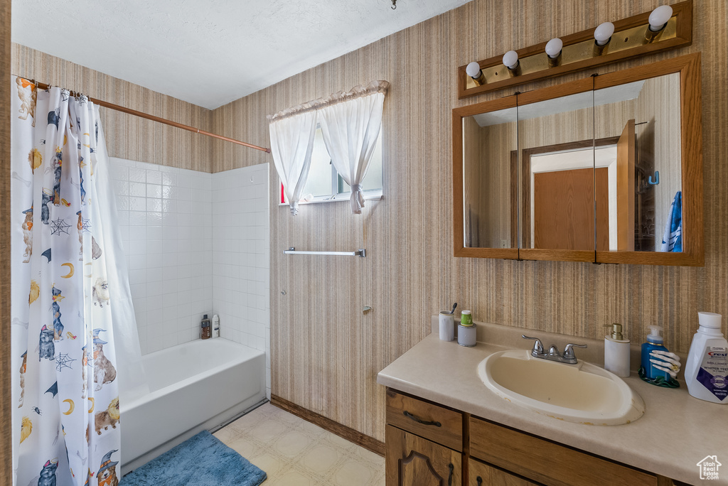 Bathroom featuring tile floors, shower / bath combo, and vanity