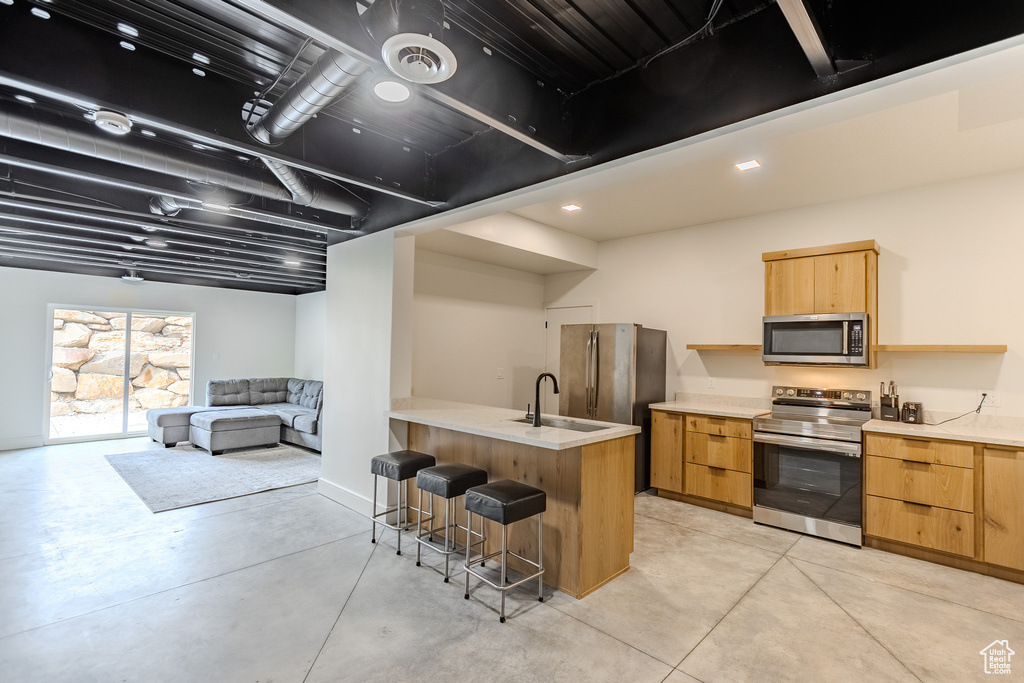 Kitchen featuring sink, a breakfast bar area, and stainless steel appliances