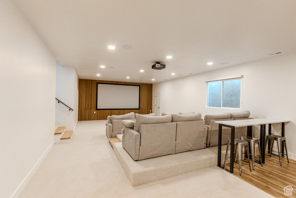 Home theater with light hardwood / wood-style flooring