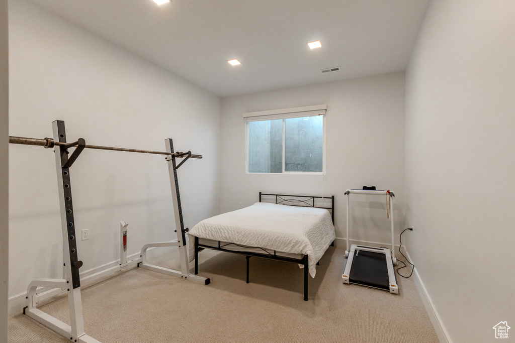 Bedroom featuring light colored carpet