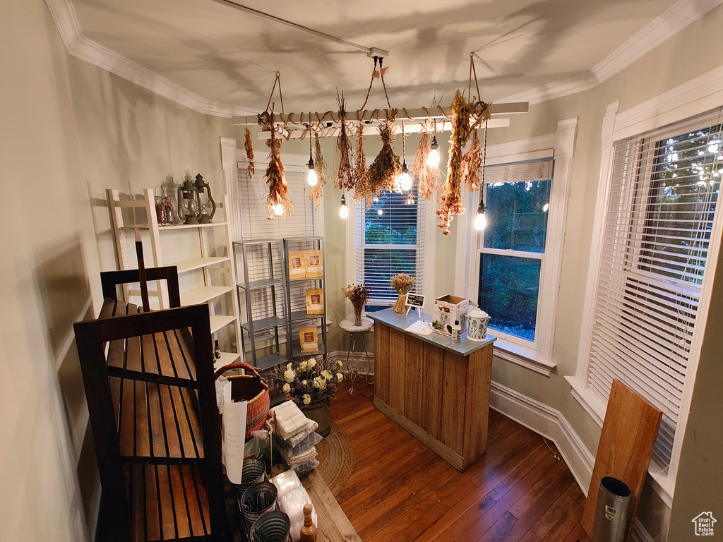 Office space featuring an inviting chandelier, crown molding, and dark hardwood / wood-style floors