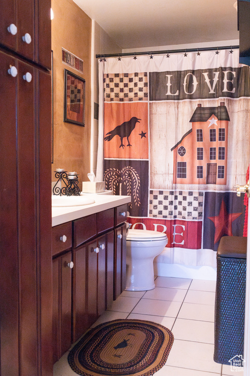 Bathroom featuring tile walls, tile flooring, vanity, and toilet