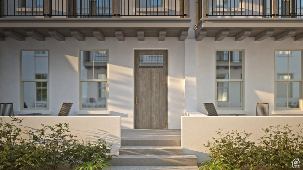 Property entrance with a balcony