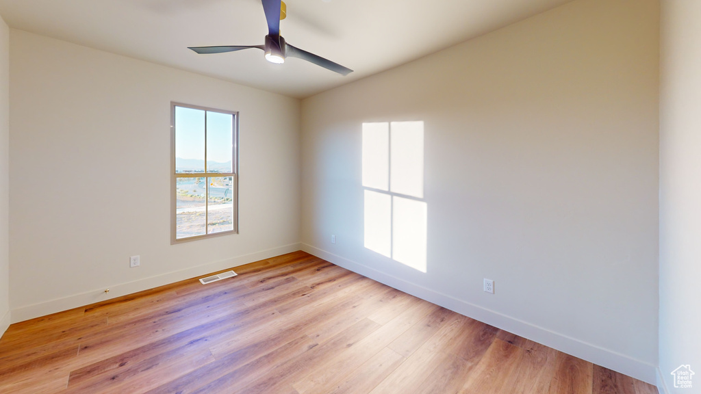 Spare room with ceiling fan and light hardwood / wood-style flooring