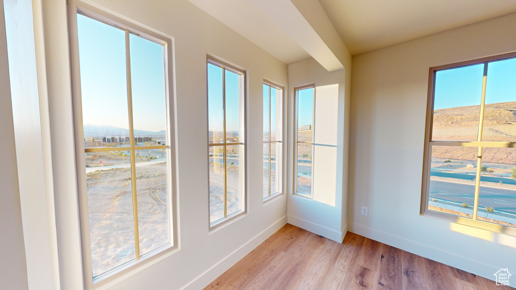 Unfurnished sunroom featuring a mountain view and plenty of natural light