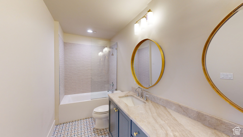 Full bathroom with tile patterned flooring, tiled shower / bath combo, vanity, and toilet