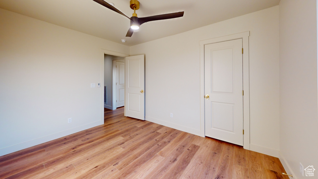 Unfurnished bedroom featuring ceiling fan and light hardwood / wood-style flooring