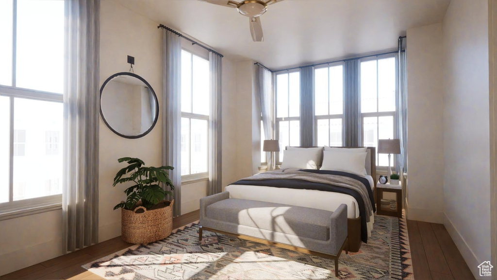 Bedroom with ceiling fan and dark hardwood / wood-style floors