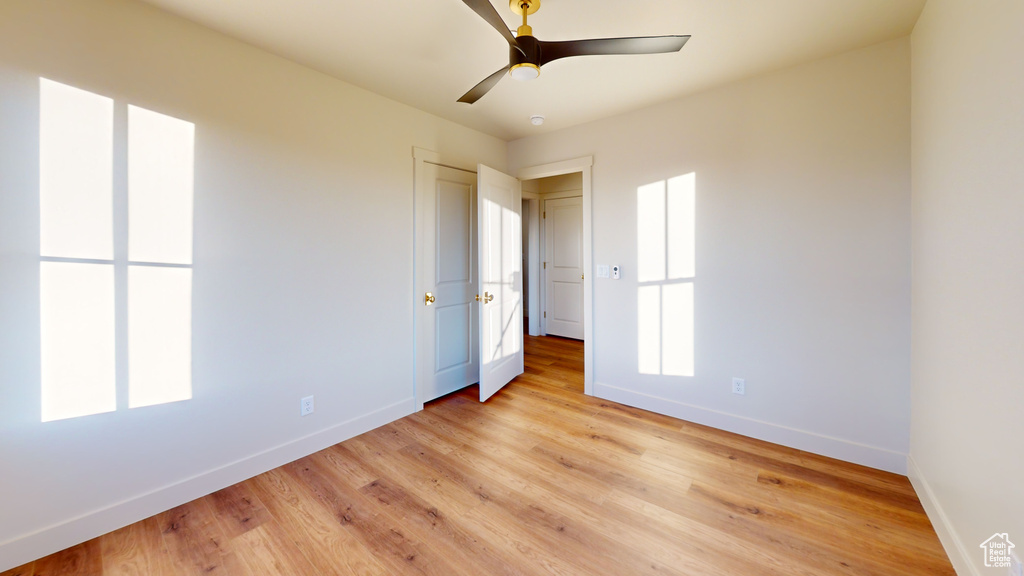 Unfurnished bedroom with light hardwood / wood-style flooring and ceiling fan