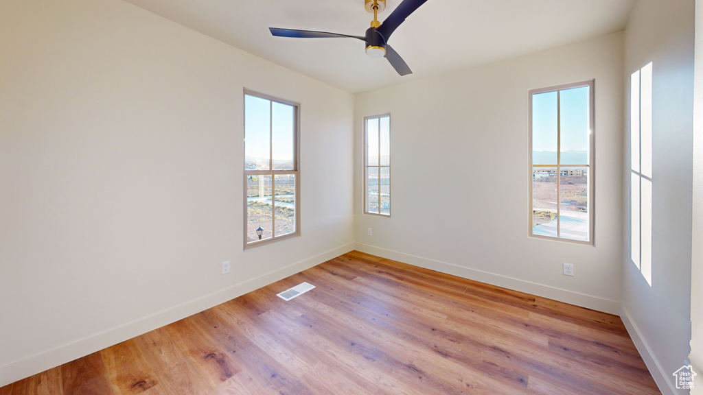 Spare room featuring light hardwood / wood-style floors and ceiling fan