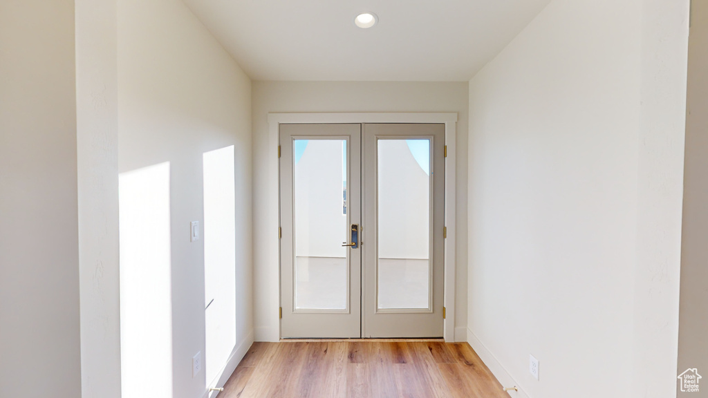 Doorway to outside with light hardwood / wood-style floors, french doors, and a wealth of natural light