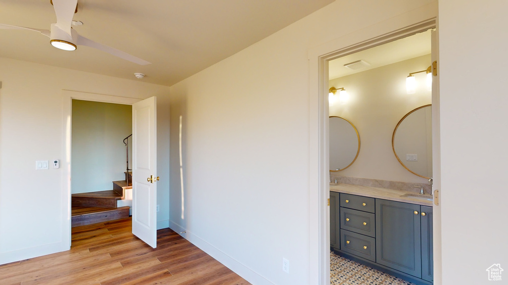 Bathroom with vanity, hardwood / wood-style floors, and ceiling fan