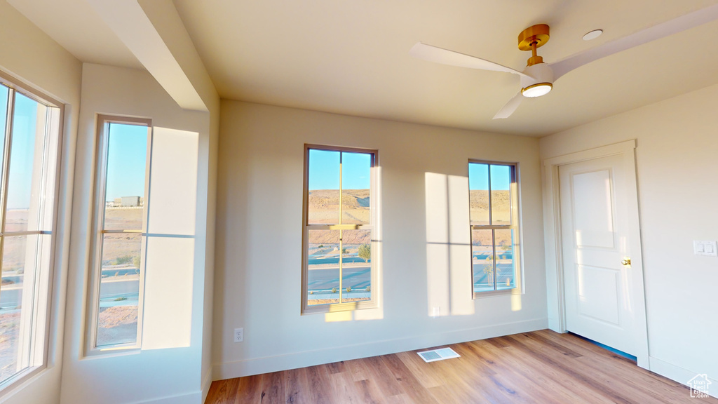 Doorway to outside with light hardwood / wood-style floors and ceiling fan