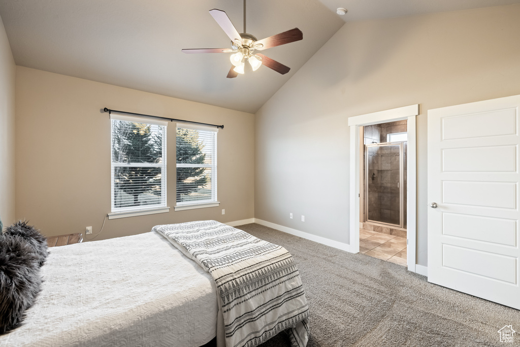 Bedroom with ensuite bathroom, light colored carpet, high vaulted ceiling, and ceiling fan