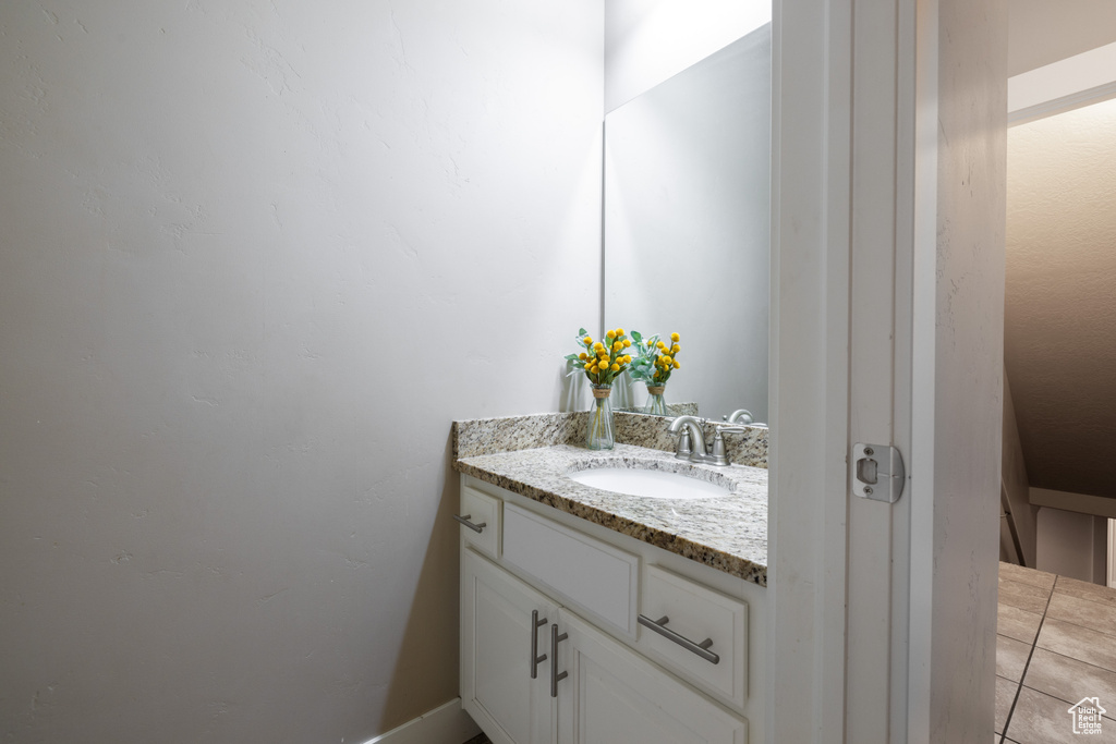 Bathroom featuring tile flooring and large vanity