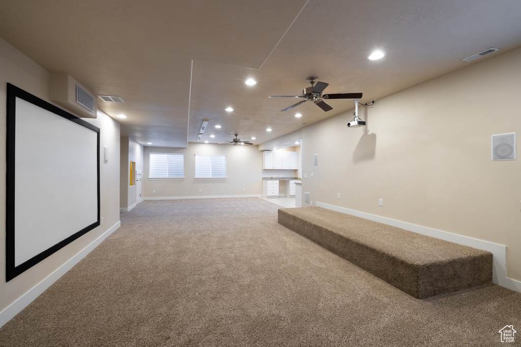 Interior space with light carpet and ceiling fan