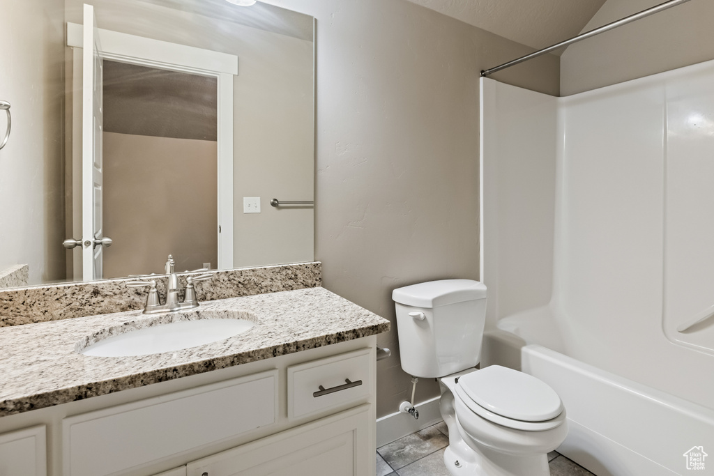 Full bathroom featuring bathtub / shower combination, tile floors, oversized vanity, and toilet