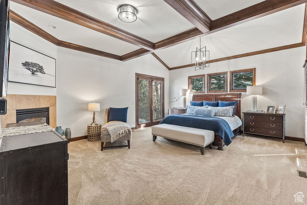 Bedroom featuring ornamental molding, vaulted ceiling with beams, light carpet, a fireplace, and a notable chandelier