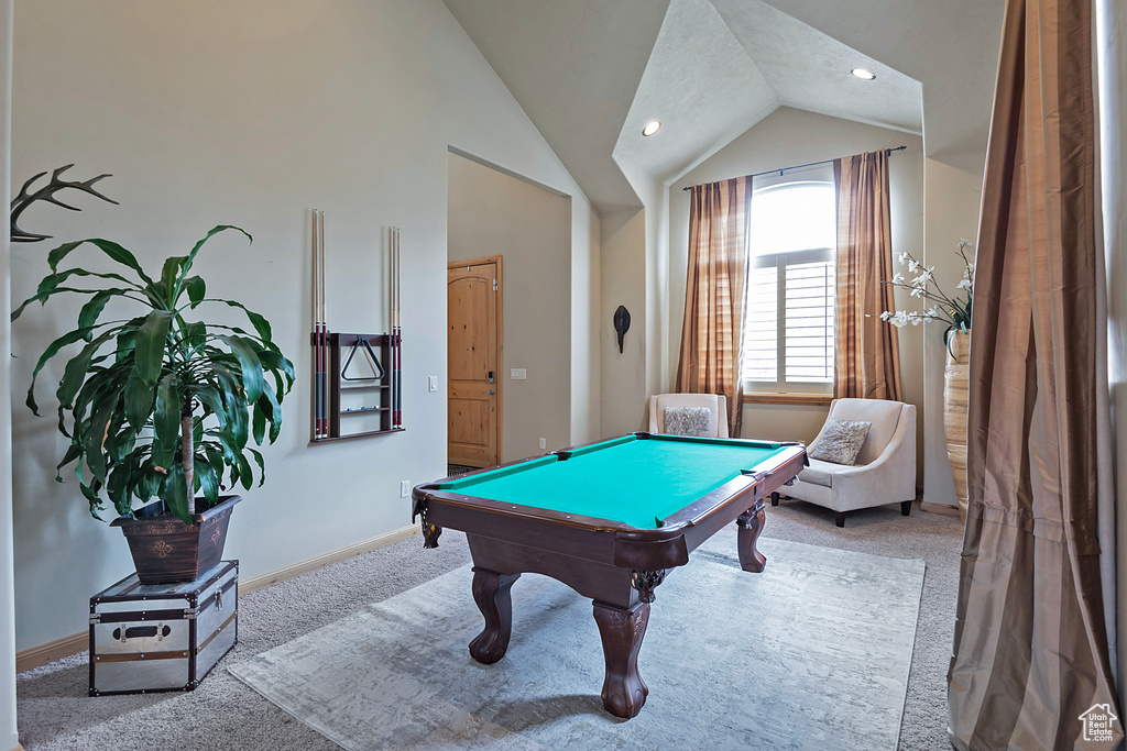 Recreation room with vaulted ceiling, pool table, and light carpet