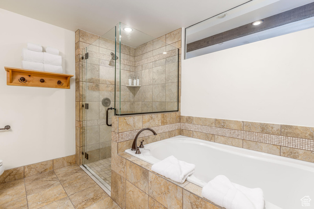 Bathroom featuring tile flooring and separate shower and tub