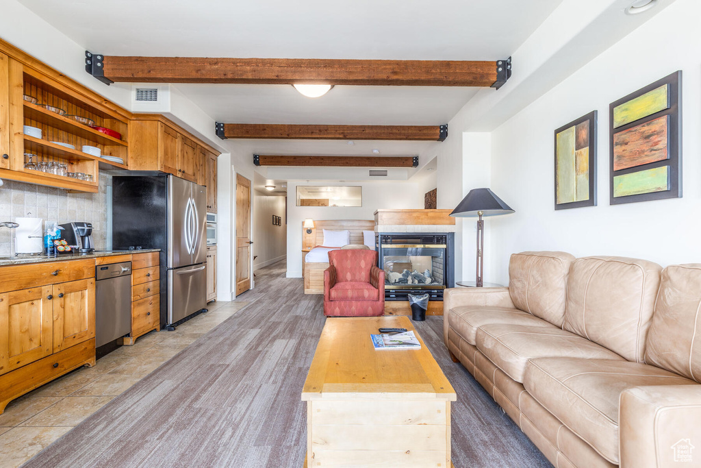 Tiled living room featuring beamed ceiling