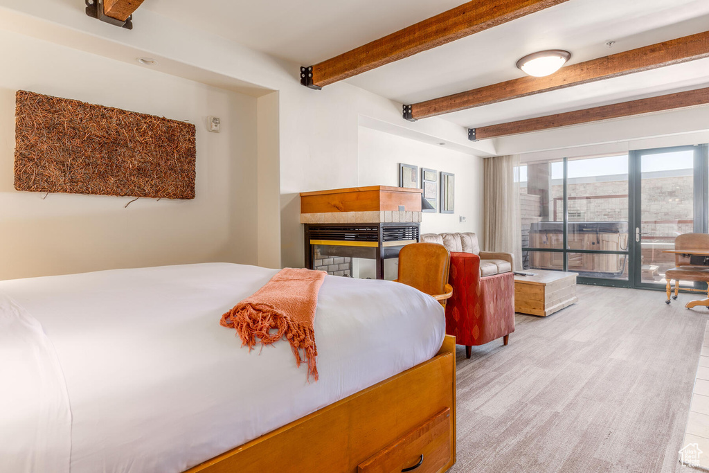 Bedroom featuring beam ceiling and a multi sided fireplace