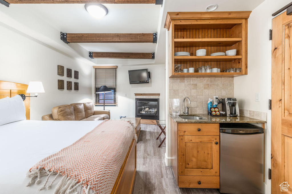 Bedroom with beam ceiling, sink, and dark wood-type flooring