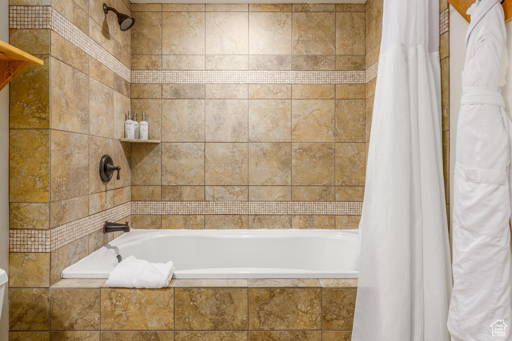 Bathroom featuring shower / bath combination with curtain