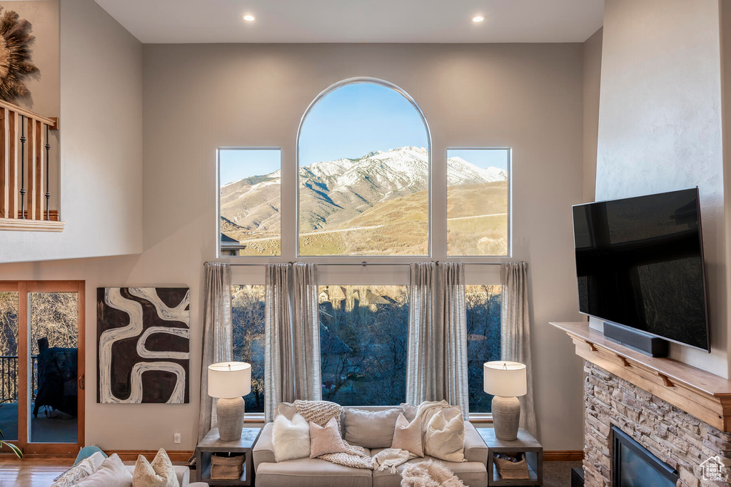Living room featuring a fireplace, a mountain view, and hardwood / wood-style flooring