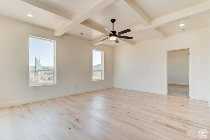 Unfurnished room with ceiling fan, beam ceiling, and light hardwood / wood-style floors