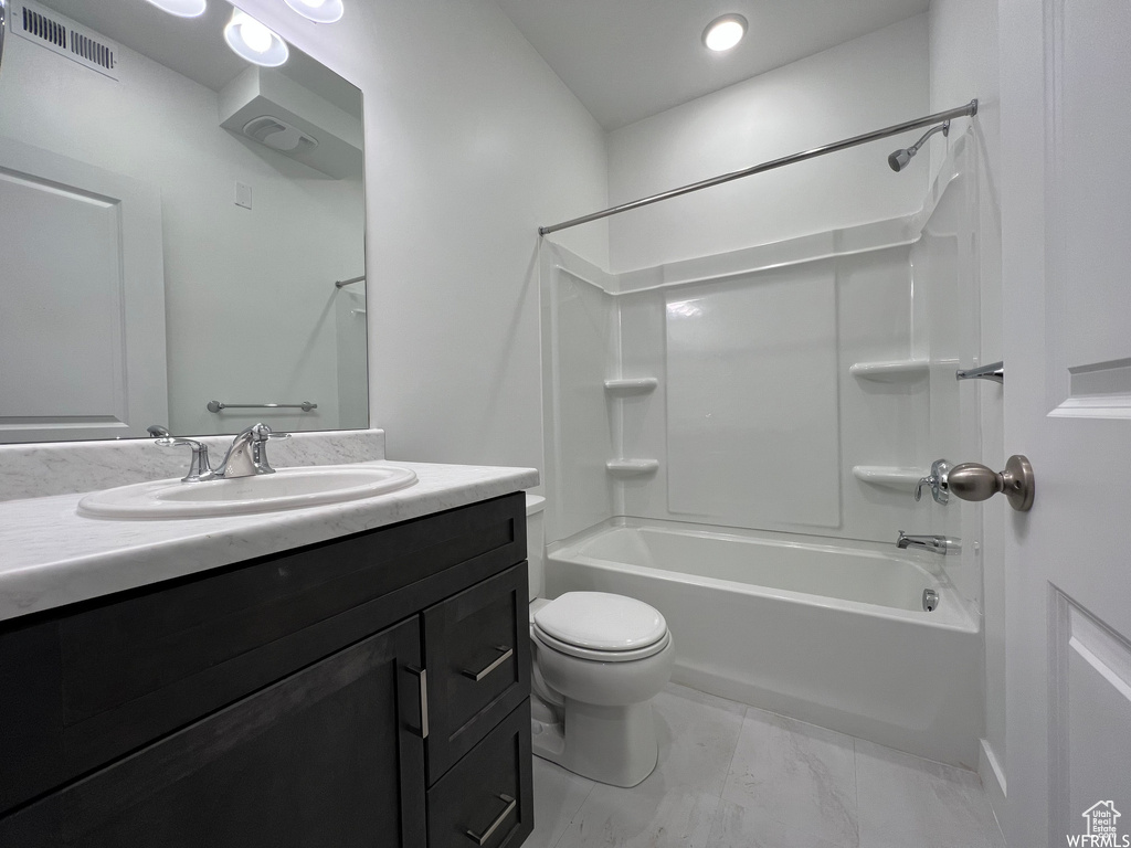 Full bathroom with tile floors, toilet, bathtub / shower combination, and oversized vanity