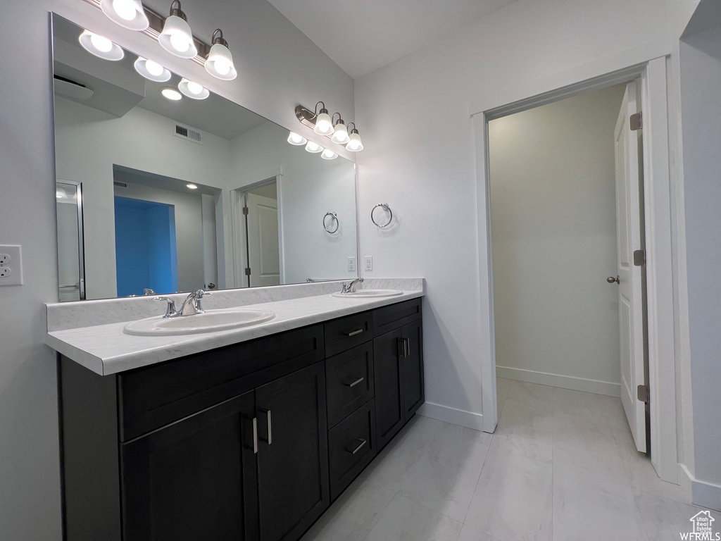 Bathroom with double sink vanity and tile floors