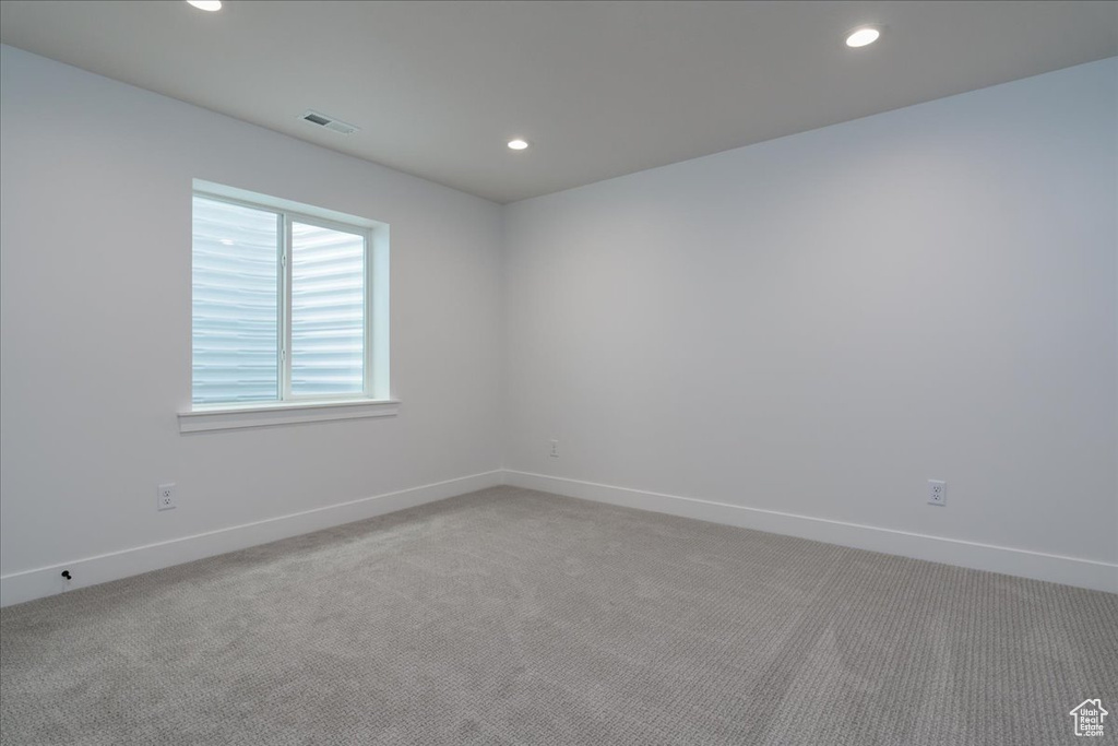 Empty room with light colored carpet