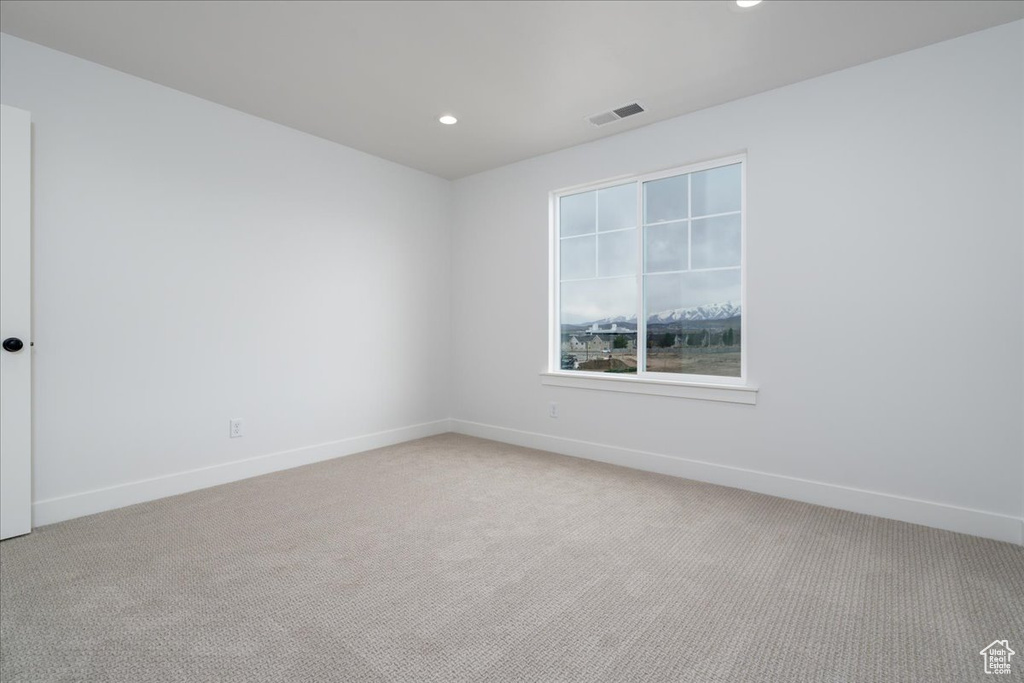 Unfurnished room with light colored carpet